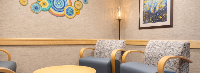 An interior photo of a group therapy room with colorful artwork