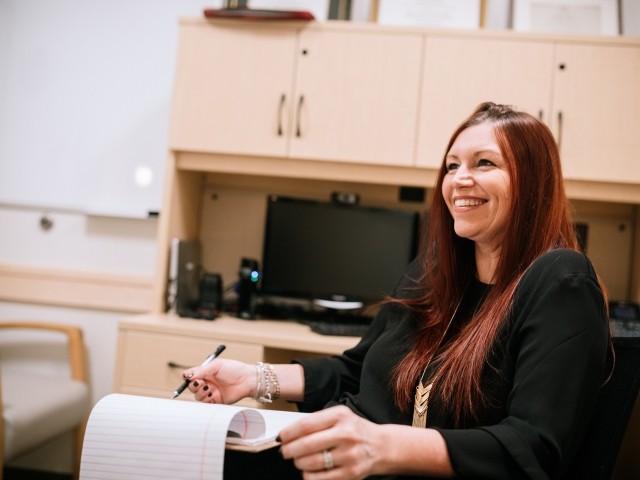 A clinician in her office