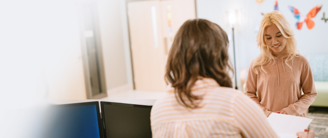 A patient begins her admissions process