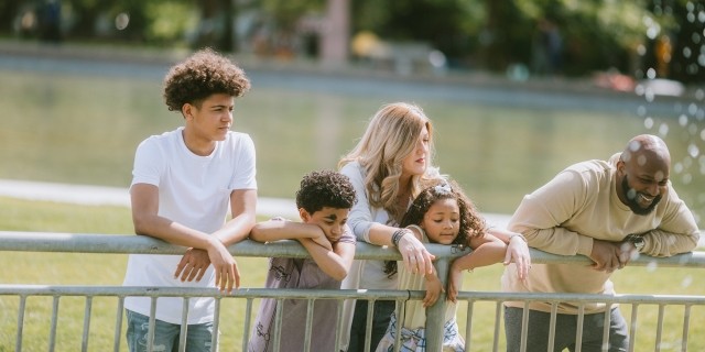 A family at a park near a fountain