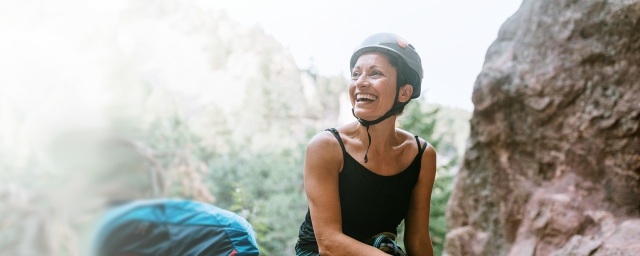 A woman rock climbing in the mountains