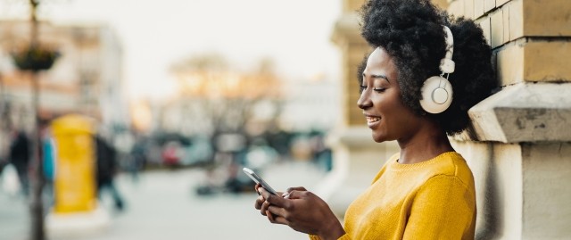 A woman listens to a podcast