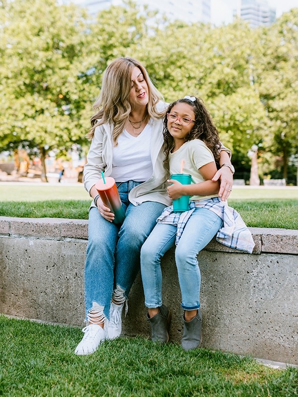 A mother and child sitting outdoors