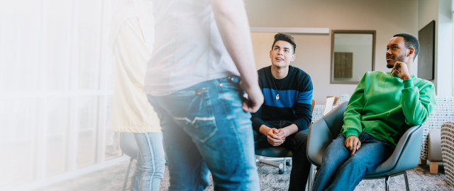 A group of patients talk together in a treatment center