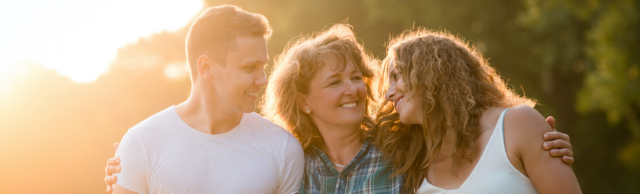 A woman is walking with her two adult children