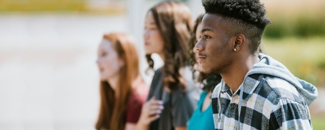 A group of adolescents sitting outdoors