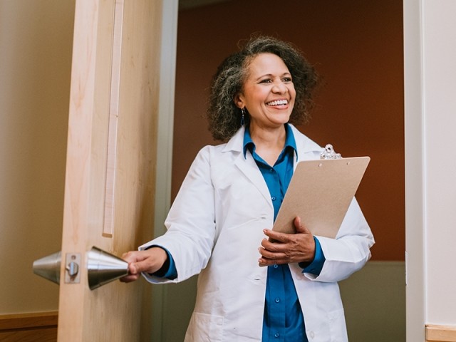 A female clinician enters a room in a treatment center