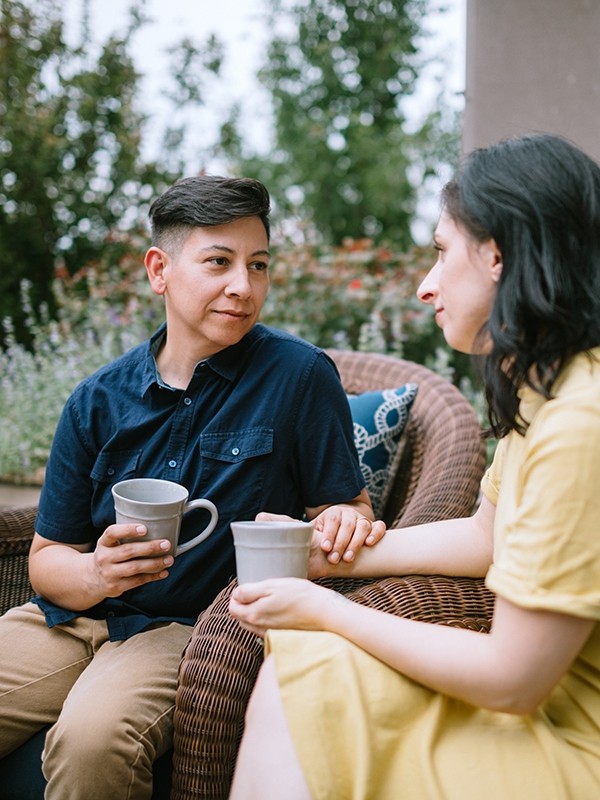 A couple sits outdoors together