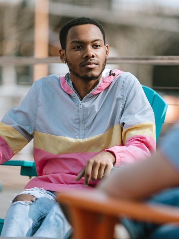 A man sitting outdoors with friends