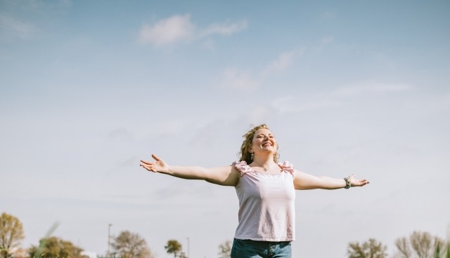 A woman is standing in a flower field