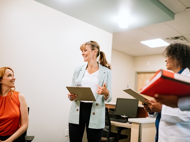 A group of clinicians speaking together in a treatment center