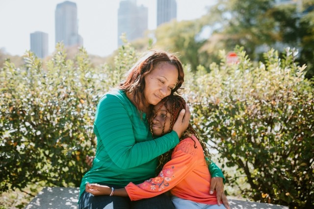 mother hugging daughter
