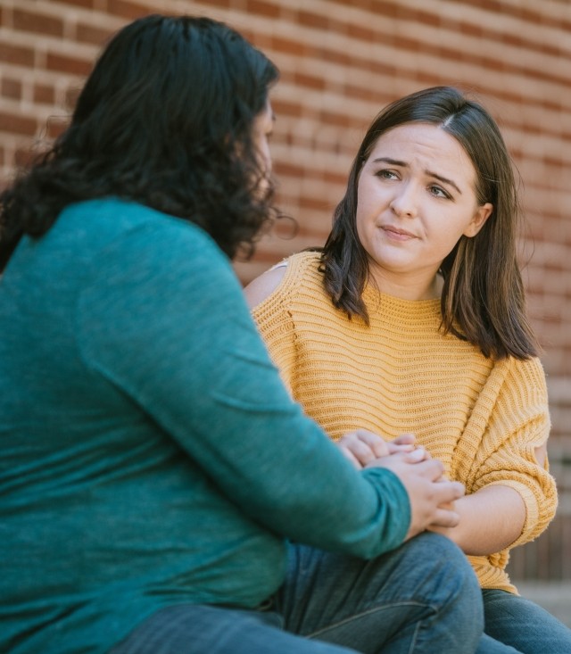 woman comforting friend with atypical anorexia, an eating disorder