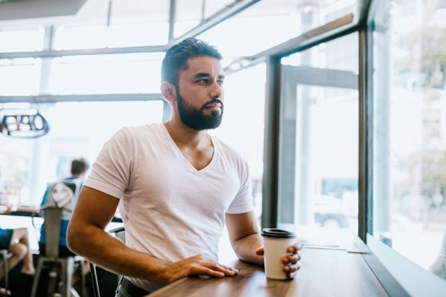 Person grabs coffee before work while struggling with depression and the “Sunday scaries.