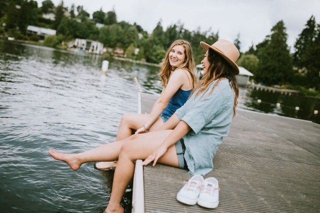 Two women sitting on a dock