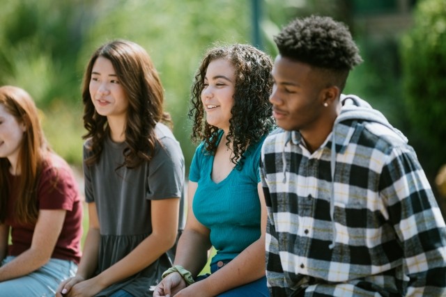adolescents sitting outside